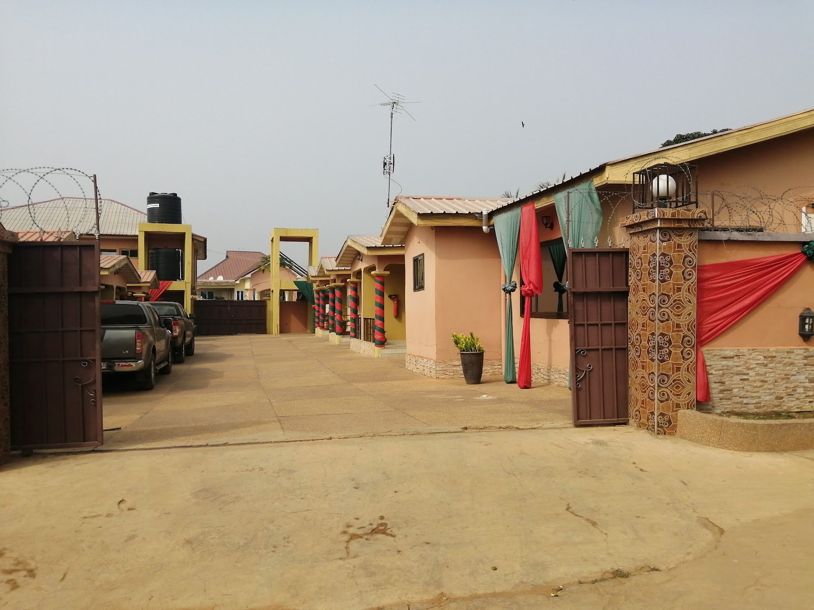 The secure entrance and parking area at MagJohn Hotel