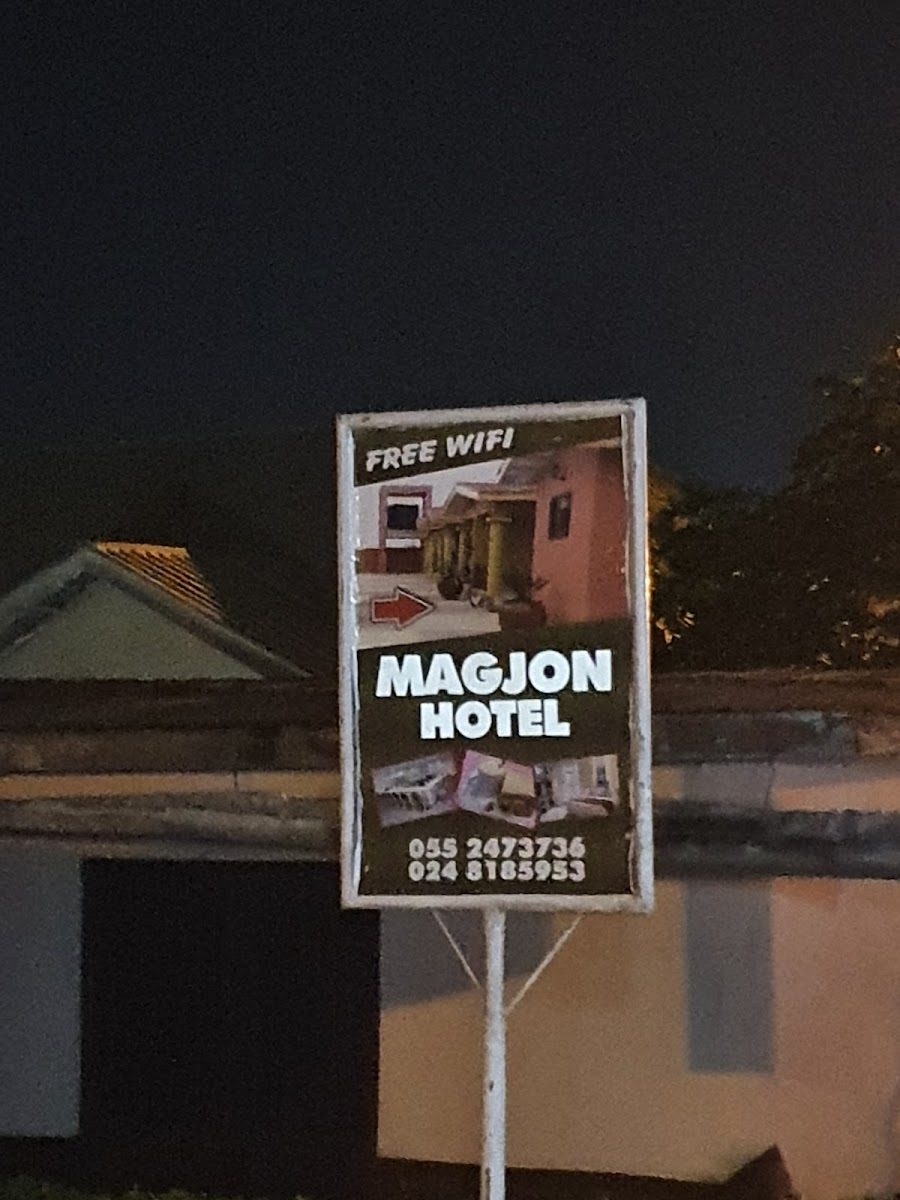 MagJohn Hotel roadside sign at night